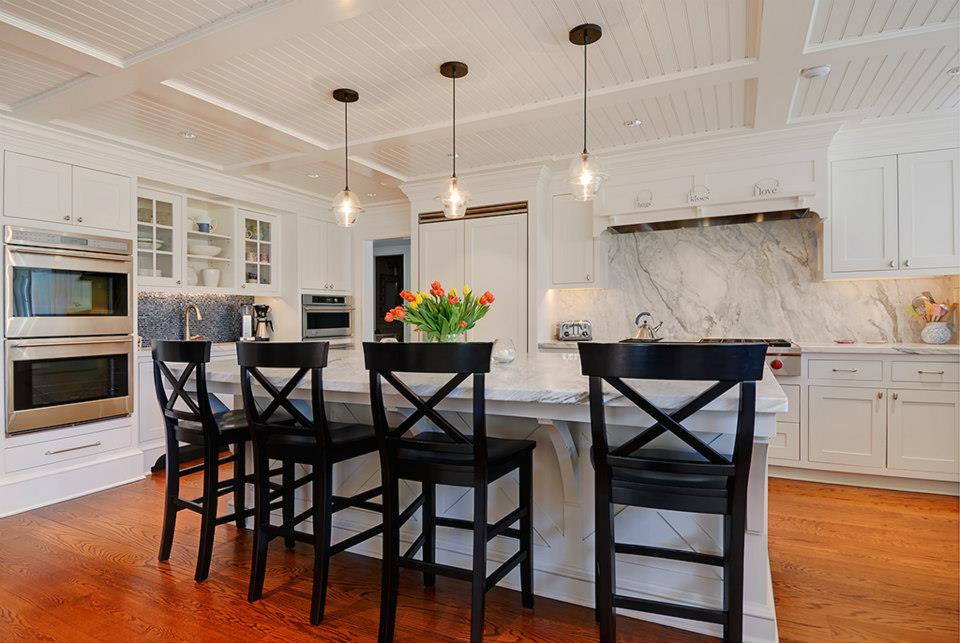 Timber-beam kitchen with butcher block island and stainless appliances