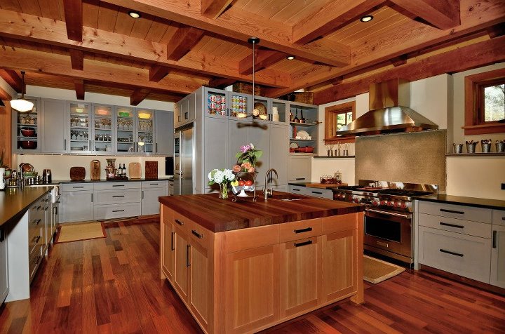 White kitchen with marble island, pendant lighting and bar seating